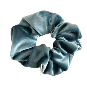 Elegant Morandi blue velvet scrunchie with soft texture and natural pleats on white background