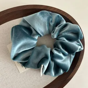 Morandi blue-green velvet scrunchie with premium texture and artistic brand label