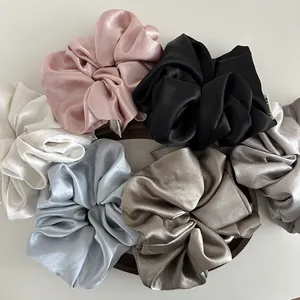 Set of six oversized satin hair scrunchies in elegant pastel and neutral colors