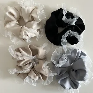Set of four retro french style satin scrunchies with white lace edges in neutral colors