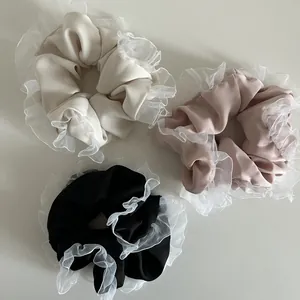 Detailed set of three large ruffled scrunchies with white mesh lace in silk-like fabric