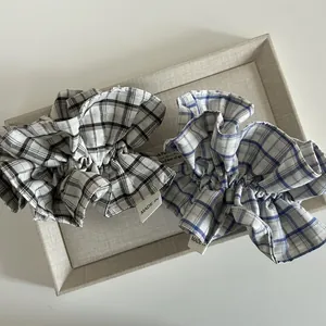 Elegant checkered ruffle scrunchies in black and blue patterns with premium fabric