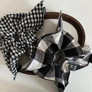Handmade black and white checkered oversized scrunchies with elegant bow details