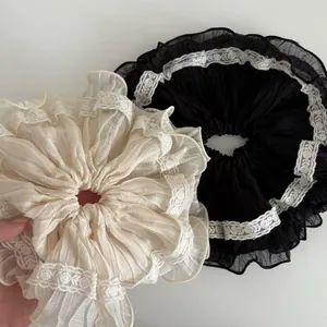 Elegant oversized scrunchie with pleated chiffon fabric and delicate lace edging