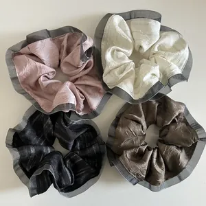 Elegant four-piece pleated fabric scrunchies set with mesh lace edges in assorted colors