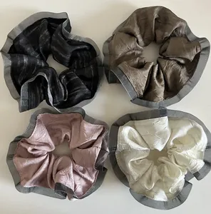 Detailed set of four pleated hair scrunchies with mesh lace edges in neutral colors