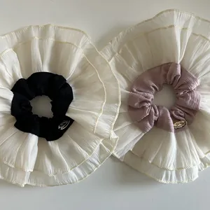 Oversized double-layered lace scrunchies in black and pink with stylish golden label