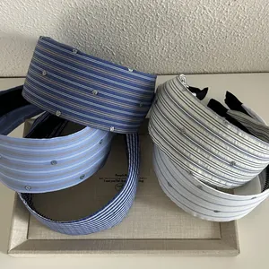 Close-up of blue and white striped fabric headbands with sparkling rhinestone embellishments