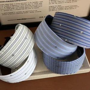 Detail of wide striped headbands with subtle rhinestone accents in various blue tones
