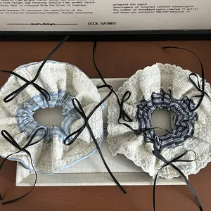 Blue striped lace scrunchie with a black ribbon bow for an elegant ponytail style