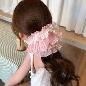 Oversized pink layered chiffon hair scrunchie with pleated lace on a ponytail