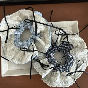 French retro oversized lace and blue striped scrunchie with a black ribbon bow detail