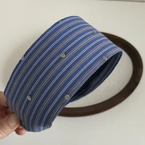 Detail of blue striped headband with delicate silver sequin flower patterns