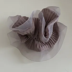 Detail of layered purple organza scrunchie with pleated texture for hair styling
