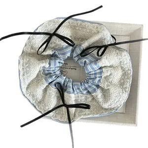 Blue striped oversized scrunchie with white lace trim and black ribbon bows
