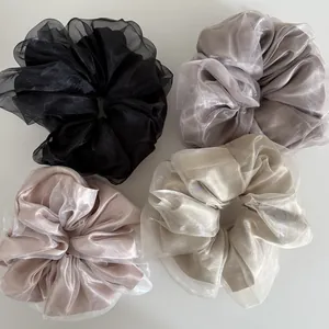 Set of four pearlescent organza scrunchies in black, purple, champagne and pink colors
