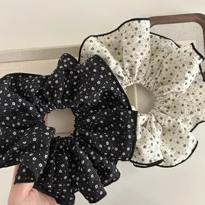 Floral print oversized fabric scrunchies in black and white with star pattern