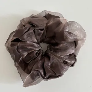 Detailed view of large dark brown scrunchie with pearlescent double-layer mesh fabric