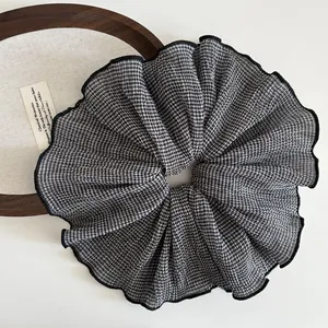 Detail of vintage black and white checkered scrunchie with pleated chiffon texture