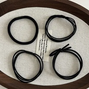 High-elasticity black hair tie set with multiple styles in a minimalist wooden tray