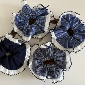 Set of four navy blue and checkered scrunchies with white ruffles and small bows