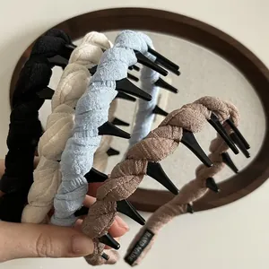 Detail of twisted fabric headband with integrated hair teeth for styling messy hair