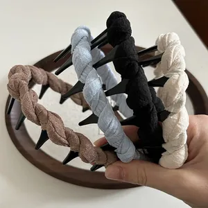 Close-up of braided fabric headbands with anti-slip teeth in four neutral colors