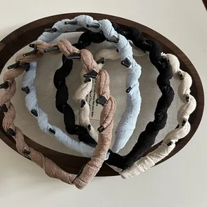 Detail of twisted fabric headbands in four colors with inner teeth for non-slip grip