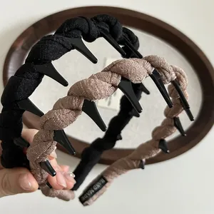 Close-up of handmade braided headbands with non-slip teeth and Hand Made label