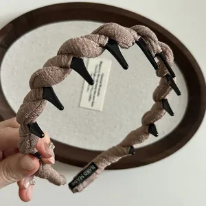 Close-up of twist wave headband with internal non-slip teeth and Hand Made label