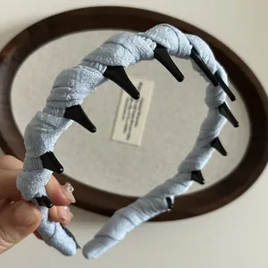 Detail of light blue pleated headband with non-slip inner teeth for secure hair grip
