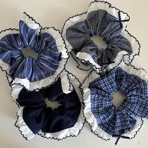 Set of 4 navy blue plaid scrunchies with white ruffle edges and small bow details