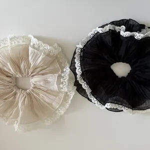Set of large ruffled chiffon scrunchies with white lace trim in cream and black