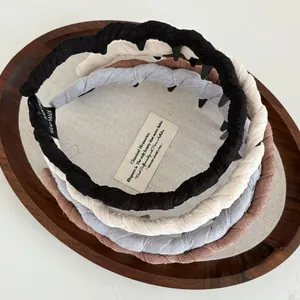 Braided fabric headbands with non-slip teeth in black, blue, beige, and brown colors