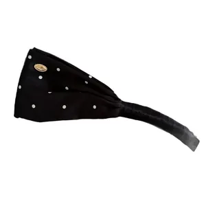 Eleganter Haarreif aus schwarzem Satin mit weißen Punkten und goldenem Zierelement-Etikett