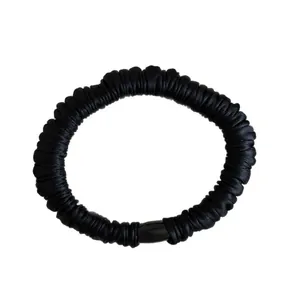 Elegant black satin hair scrunchie with high-density pleats and premium silky texture