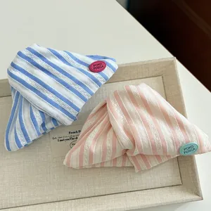 Close-up of striped fabric hair clips with colorful POKO FDSCA brand logo patches