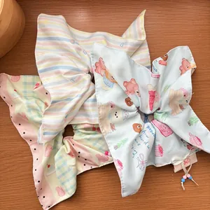 Detail of macaron color bow hair scrunchie with cute bear print and beaded string