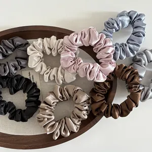 Detailed set of 8 satin silk scrunchies in various colors on a wooden tray