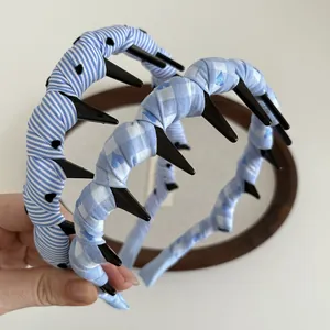 Detail showing blue plaid and striped fabric headbands with anti-slip teeth and heart pattern
