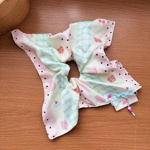 Close-up of cute striped scrunchie with cartoon bear bunny print and blue ribbon bow