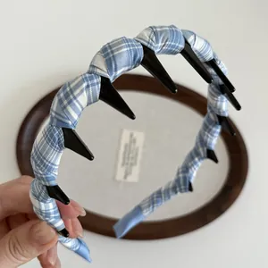 Detail view of the blue plaid fabric headwrap and the black anti-slip teeth design