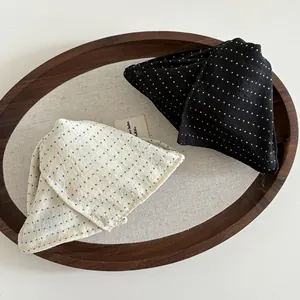 Detailed macro view of French style polka dot fabric textures in a wooden tray