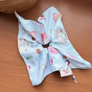 Close-up of a blue printed scrunchie with a cute bow charm on a wooden surface