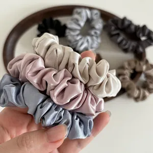 Detail of satin scrunchies in various Morandi colors with a lustrous silk-like finish