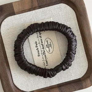 Deep brown satin silk pleated hair scrunchie with a sleek black cylinder fastener