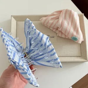 Striped fabric hair claw clips in blue and pink patterns for elegant updo hairstyles