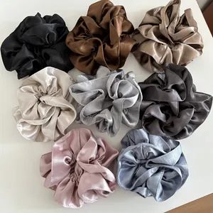 Detail of multi-color satin scrunchies set in smooth silk-like fabric for ponytails