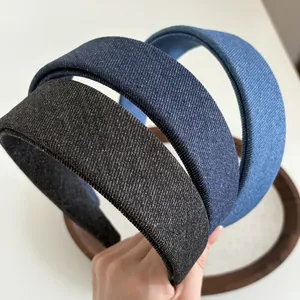 Close-up of triple-tone denim headbands in black, dark blue, and light blue fabric textures