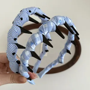 Set of two blue plaid and striped headbands with inner teeth and heart patterns